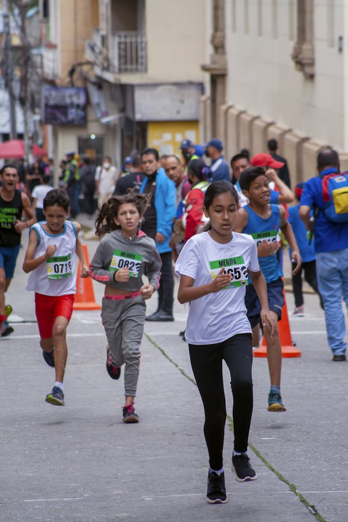 Energetic children participating in a street marathon race in Venezuela.